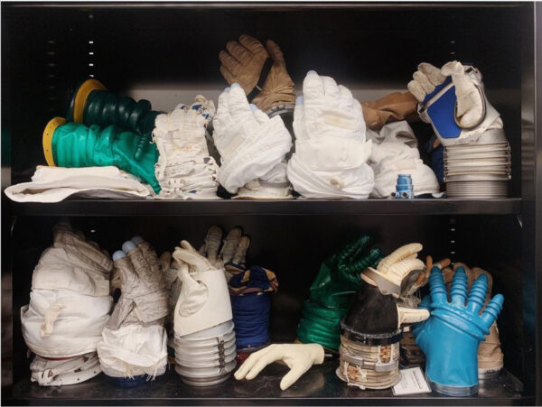 Various industrial gloves on a shelf