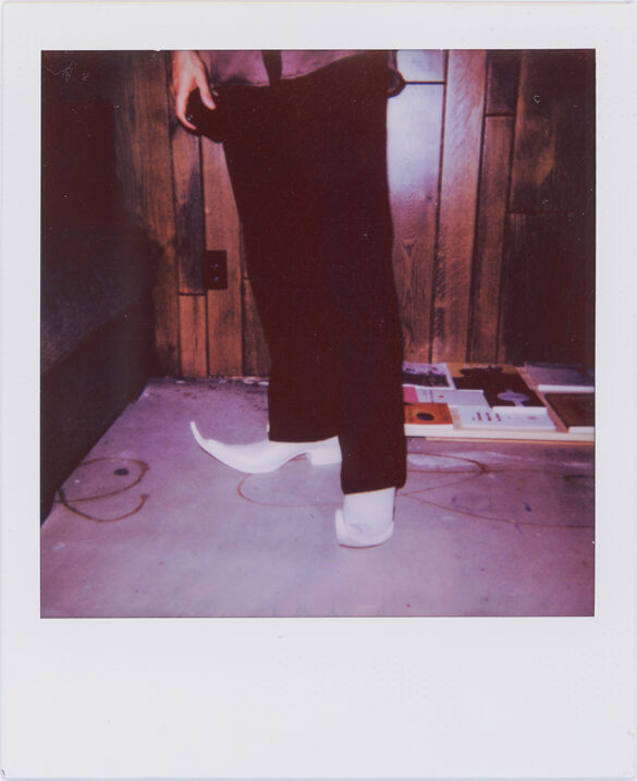 A polaroid of a person's boots taken at El Refugio by Christopher Sonny Martinez.