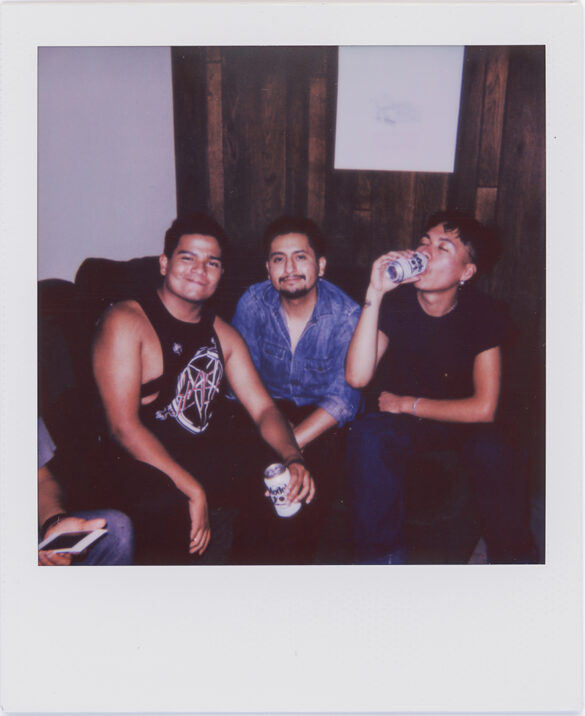 A polaroid of three men sitting on a couch, taken at El Refugio by Christopher Sonny Martinez.