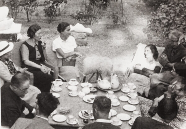 People sitting around at an outdoors picnic