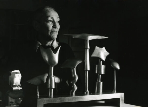 Oppenheim in her studio behind small sculptures