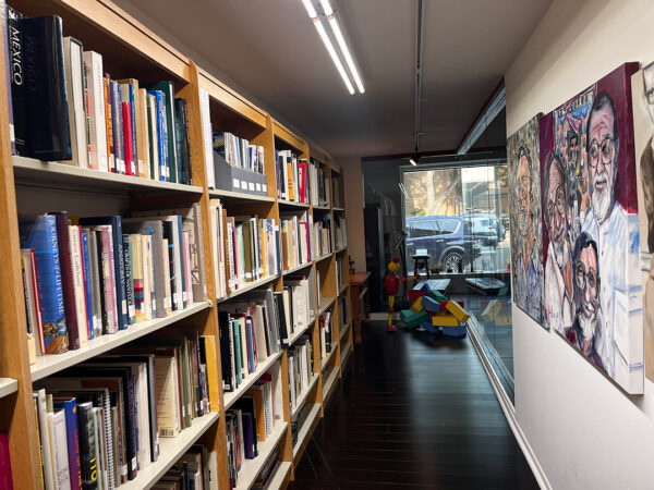 A photograph down a long narrow library within the Center for Contemporary Arts.