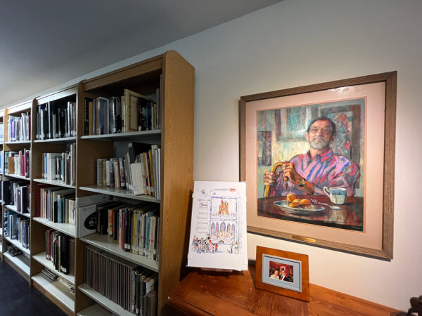 A photograph of a painting of Clint Hamilton by Marie Tumlinson, hanging in the Center for Contemporary Arts library.