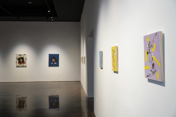 Installation view of paintings on a white wall
