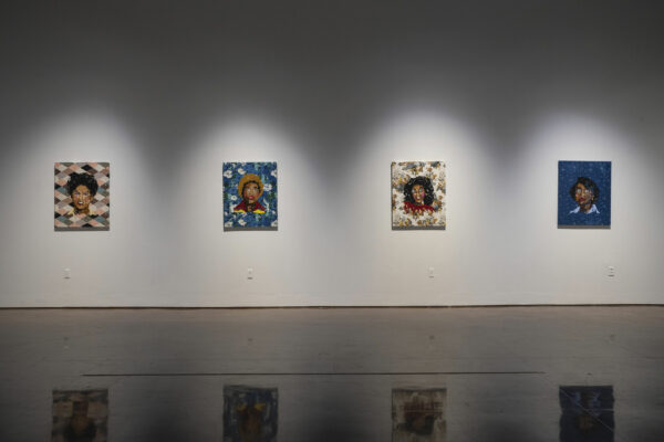 Installation view of four paintings on a white wall