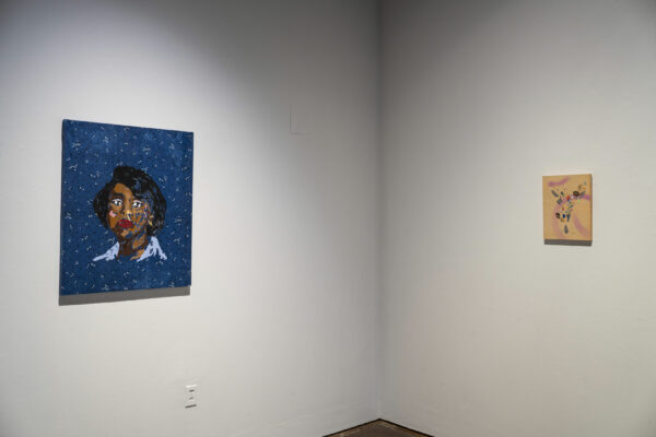 Installation view of two paintings on a white wall and in a corner