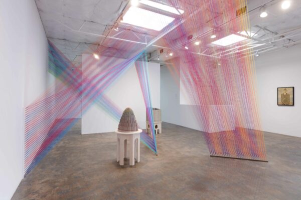 Installation view with String from floor to ceiling and unfinished puzzles