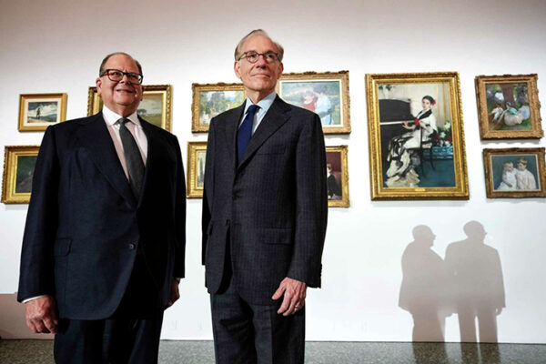 A photograph of Christopher Sarofim and Gary Tinterow, Director of the Museum of Fine Arts, Houston, in front of some of the art Sarofim’s family is loaning to MFAH. 