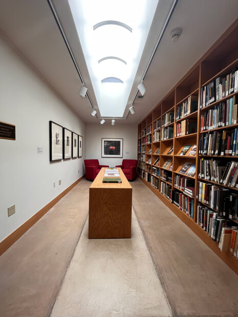 A photograph of a long narrow room inside the Old Jail Art Center library.