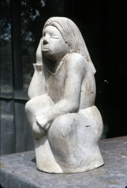 Image of a sculpture of a girl sitting