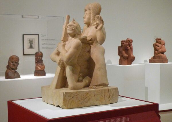 Image of a sculpture of a woman and a man holding a rifle in an exhibition