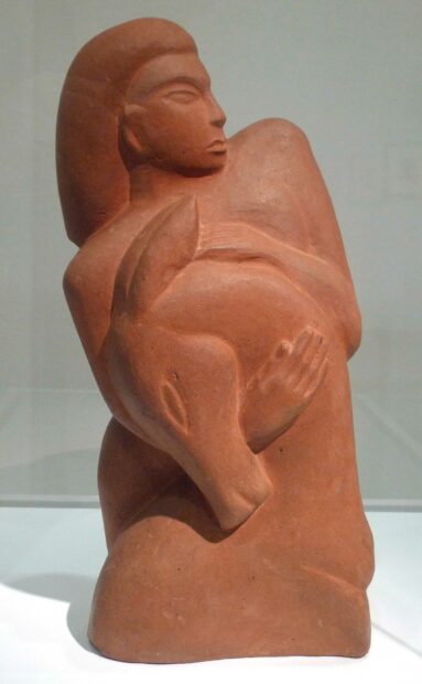 Terra cotta sculpture of a woman holding a deer