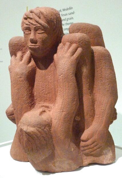 Sculpture of two people struggling, a man on top of a woman