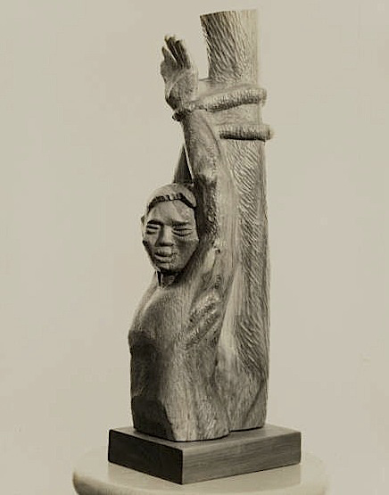 Photo of a sculpture of a woman tied to a pole