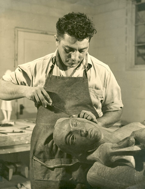 Artist in the process of working on a sculpture