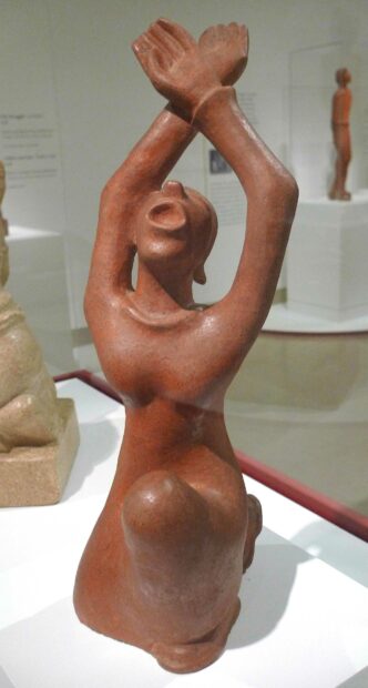 Terra Cotta sculpture of a woman with her hands raised