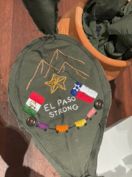 Embroidery on a fabric sculpture of a cactus that says "El Paso Strong"