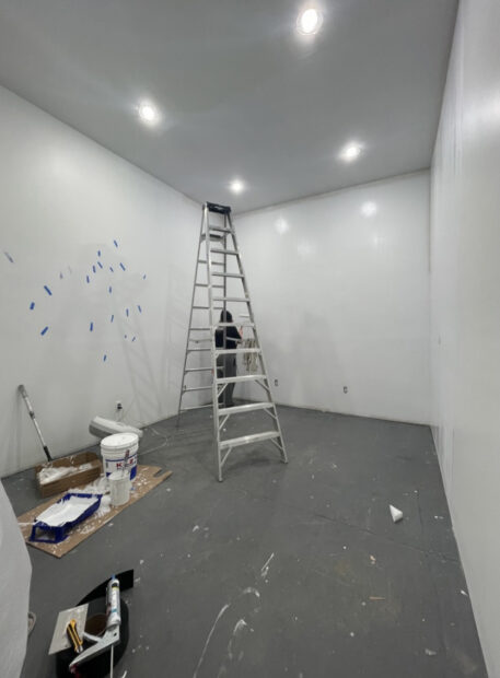 Process image of a studio buildout with a ladder in the middle of the space