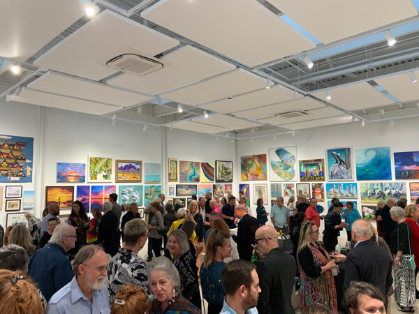 A photograph of a large crowd in a gallery at the Rockport Center for the Arts.