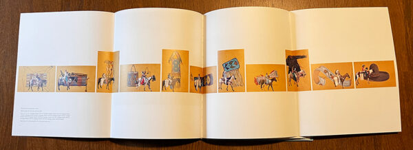 A photograph of the book "Speaking with Light: Contemporary Indigenous Photography" opened to an extended page depiction of 11 photographic works by Wendy Red Star.