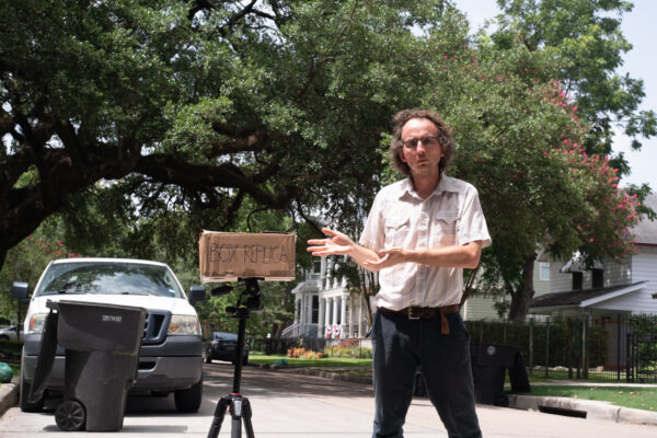 Bucky Miller standing next to a box replica