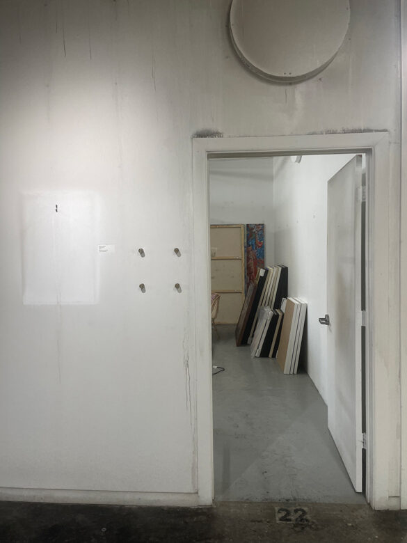 A photograph of the hallway and the entry of Erika Alonso's studio covered in soot.