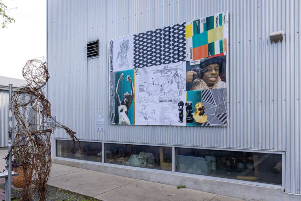 A temporary mural by Gregory Michael Carter featuring a collage of pop culture images.
