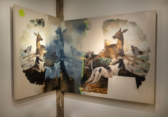 A photograph of a work of art by Adde Russell. The work includes two canvases featuring a dog chasing deer. The canvases are placed in the corner of the room so that they are touching.