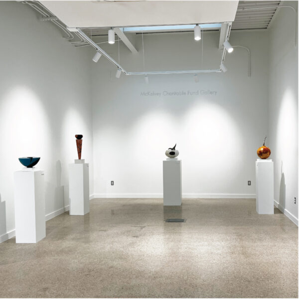 An installation photograph of multiple wall mounted and 3D ceramic artworks in a gallery.