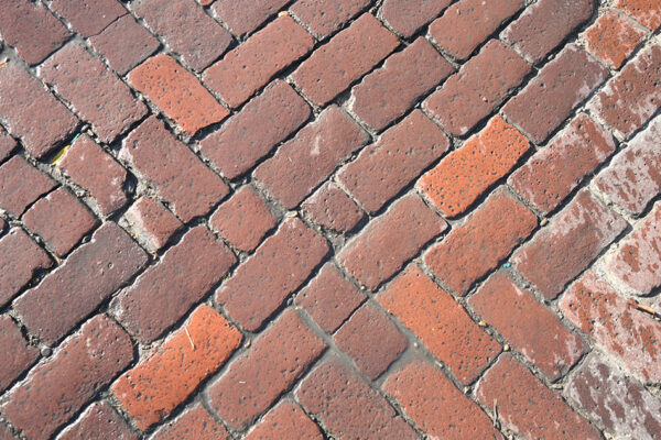 A photograph of Historic Freedmen’s Town bricks at the intersection of Wilson Street and Andrews Street.