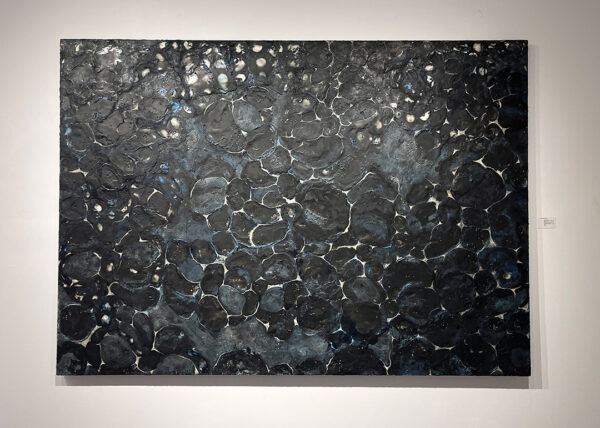 A large black and blue encaustic painting by Janet Chaffee.