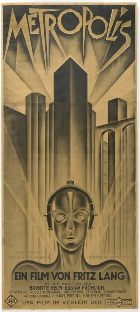 A monochrome lithograph poster for the movie Metropolis. The poster features a human-like robot in front of a downtown skyline.