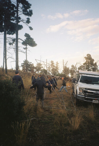 Photo of people setting up a structure for camping