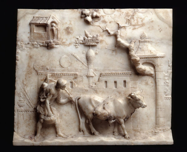 A small Roman marble relief featuring a herdsman and his cow in front of an architectural scene.