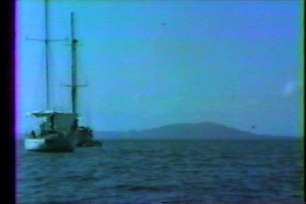 Grainy home video of a boat on water