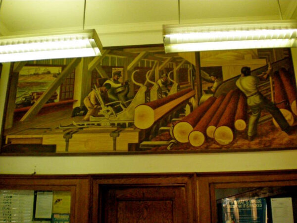 Mural of loggers above a post office door