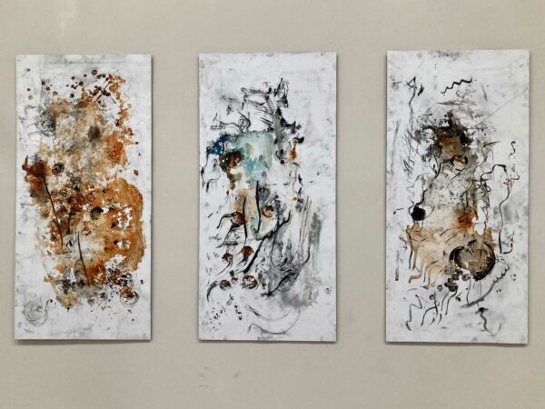 Three abstract works on a wall