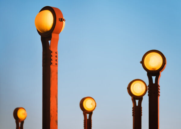 Image of red steel lampposts with round bulbs