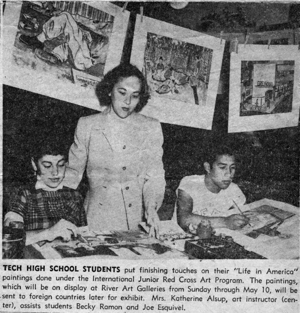 Newspaper clipping of two young men drawing at a table with their teacher between