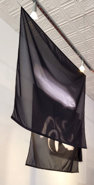 Black flags hanging horizontally from a ceiling