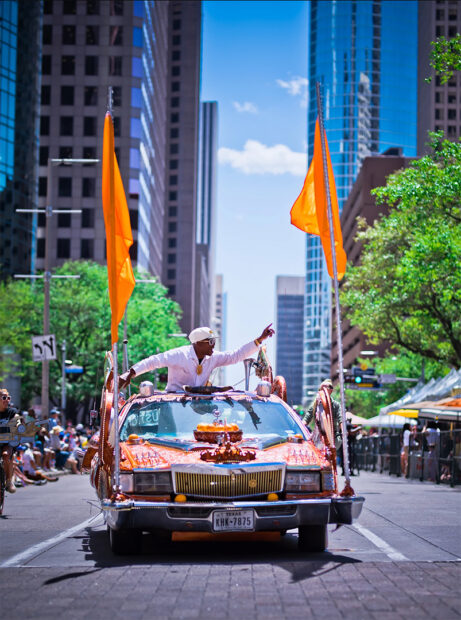 A photograph of a SLAB car with tall orange flags adhered to its front bumper.
