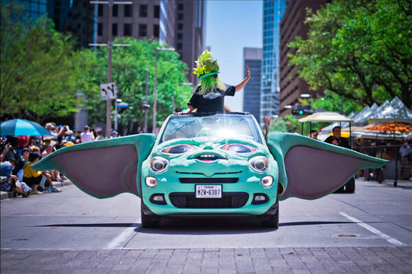 A photograph of a car transformed to look like the head of Yoda, including long ears that extend from either side of the car.