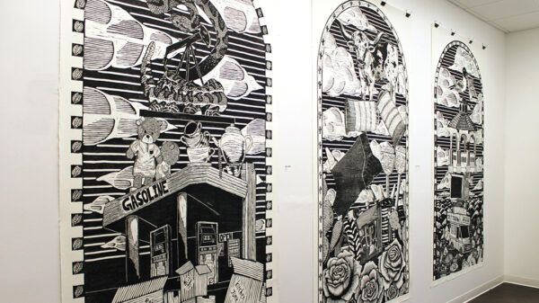 An installation photograph of three large-scale black and white prints by Ben Muñoz.