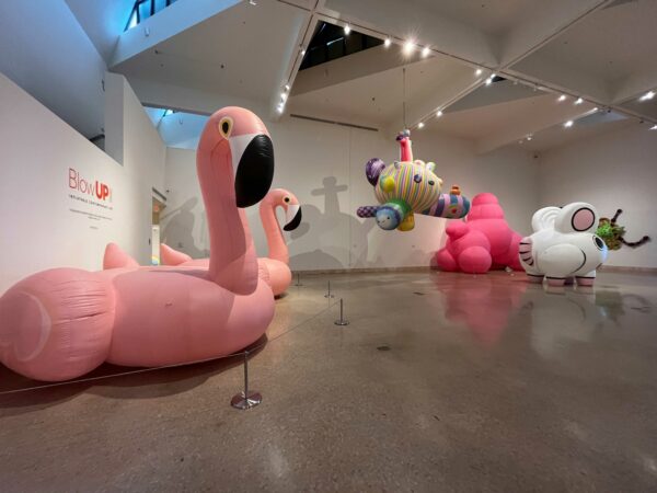 Multiple inflatable artworks are installed in a white gallery space.