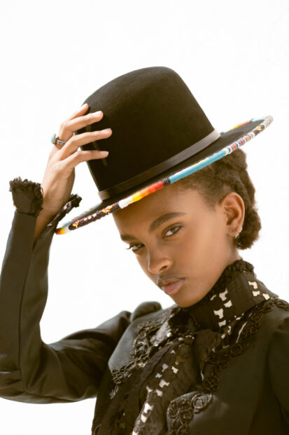 Model posing with a custom hat
