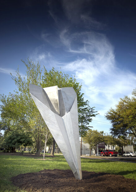 Public sculpture of a paper airplane made of aluminum