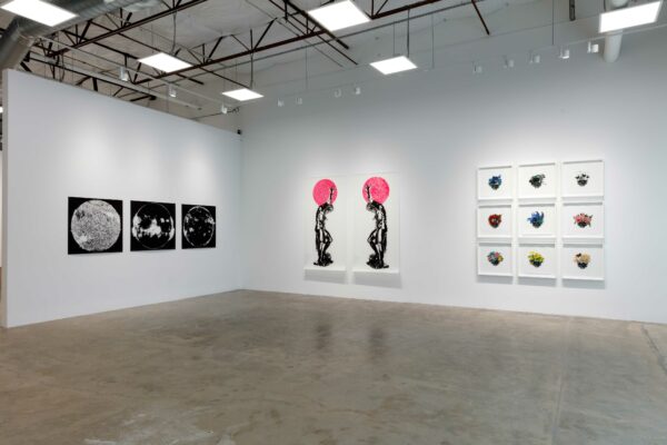 Exhibition installation view with two dimensional works on white walls