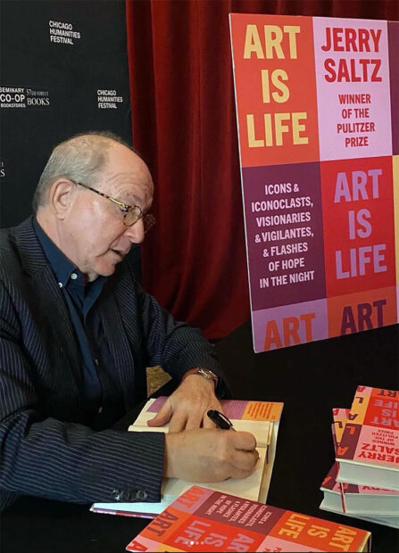 A photograph of Jerry Saltz at a book signing for his new publication "Art is Life."