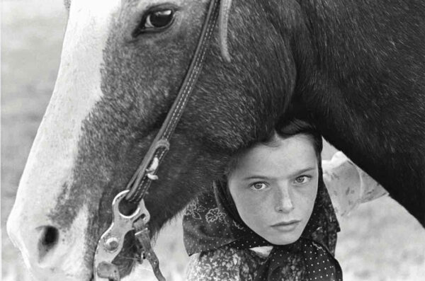 Photograph of a young girl with her horse