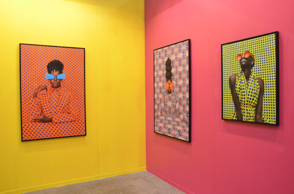 A collection of brightly colored photographs of Black women. The women stand in front of vividly patterned backgrounds.
